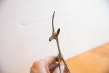 Brightly oxidized finish on the slender head and horns of a handmade African gazelle.