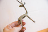 Rear view of the vintage gazelle sculpture showing its oxidized surface and back slot.