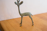 Vintage African gazelle sculpture detail: slender hindquarters and time-softened green-gray patina.