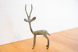 Vintage African gazelle sculpture in profile, showing its slender form and oxidized finish.