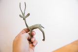 Vintage African gazelle sculpture held in hand to show its small scale and finish.