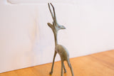 Vintage African gazelle sculpture's slender neck and horns, showing its distinctive patina.