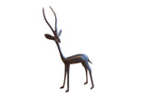 Vintage African left-facing gazelle sculpture with a dark patina and slender form.
