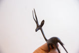 Angled view of the gazelle sculpture's head, highlighting its handmade form and dark patina.