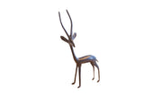 Vintage handmade African gazelle sculpture with a dark patina and slender, elegant form.