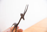 Detailed head and long, slender horns of a handmade African gazelle with a dark patina.