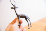 Vintage African gazelle sculpture with dark patina held to show scale.