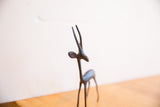 Close-up of the vintage gazelle sculpture's head, focusing on its elegant long horns and dark patina.