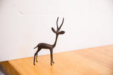 Three-quarter view of the vintage African gazelle showing its slender form and dark patina.