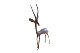 Vintage African gazelle sculpture with a slender, handmade form and a dark, aged patina.