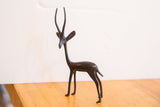 Handmade vintage gazelle sculpture with a slender profile and dark aged patina.