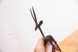 Close-up view of the gazelle's head, highlighting the slender horns and textured dark patina.