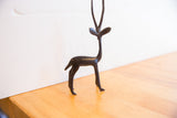 Full profile of a handmade African gazelle sculpture with a dark, textured patina.