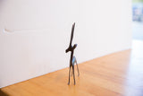 Handmade African gazelle sculpture showing its stylized form and dark patina.