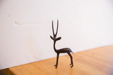 Graceful profile of the vintage African gazelle with long horns and a dark patina.