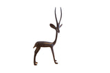 Vintage handmade African gazelle sculpture with a dark patina, facing right.