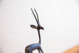 Profile view of the vintage gazelle's head, highlighting its dark patina and slender horns.