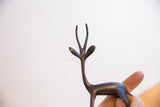 Close-up of the vintage gazelle's slender horns and head with a dark patina.