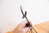 Close-up on the dark patina and handmade texture of the gazelle's head and horns.