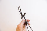 The dark patina and handmade texture on the head of the African gazelle figurine.