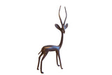 Vintage African gazelle sculpture with a slender body, long horns, and a dark patina.