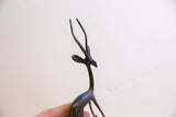 Dark patina and textured detail on the head and horns of a vintage African gazelle.