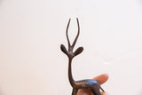 Close-up of the vintage gazelle's head and slender antlers with a dark patina.