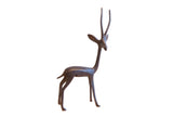 Vintage African right-facing gazelle sculpture with an elegant form and dark patina.