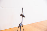 Profile view of the vintage gazelle's head, showing the dark patina and tall, slender horns.