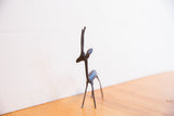 Elegant profile of a handmade African gazelle sculpture with a dark patina.
