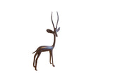 Vintage African gazelle sculpture with a slender, stylized form and a dark metal patina.