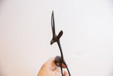 Close-up of the vintage gazelle's carved head and slender horns showing a dark patina.