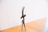 Slender silhouette of the vintage African gazelle sculpture showing its dark patina.