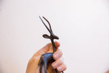 Detailed side view of the vintage gazelle's head and long, textured dark horns.