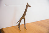 Three-quarter view of the vintage African giraffe sculpture's slender form.