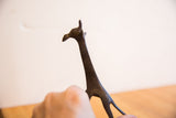 Handmade etched patterns and dark patina on the vintage African giraffe sculpture.
