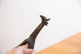 Close view of the vintage giraffe's head, highlighting the dark patina and handmade texture.