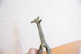 Vintage African giraffe sculpture head and neck, highlighting its time-softened green patina.