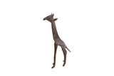 A handmade vintage African giraffe sculpture with a dark, oxidized patina and etched details.