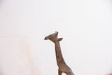 Textured details and oxidized patina on the head of a vintage African giraffe sculpture.