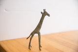 Slender vintage African giraffe sculpture showing its handmade form and oxidized patina.