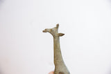 Handmade details and aged, oxidized texture on the vintage giraffe sculpture's head.