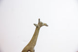 Detailed profile of the vintage oxidized giraffe's head showing its handmade textured finish.