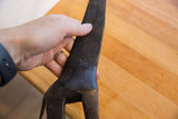 Close-up of the etched texture and dark patina on the neck of a vintage giraffe collectible.