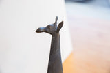 Detailed profile of the handmade African giraffe's head, showing its dark, textured patina.