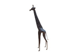 Vintage handmade African giraffe figurine with a slender form and dark, textured patina.
