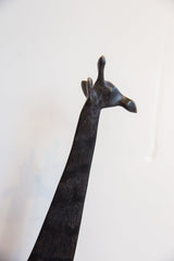 Upward view of the sculpted head and textured neck of a vintage African giraffe.