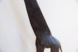Hand-carved texture and dark patina on the neck of a vintage African giraffe statue.