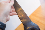 Incised textural patterns on the dark, aged patina of the vintage African giraffe figure.
