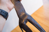 Etched surface details and dark patina on the vintage African giraffe figure.